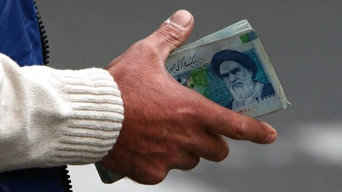 IRGC economic control Iran 2026, Iranian Rial collapse reasons, Revolutionary Guard monopoly oil sector, Iran preferential exchange rate corruption, Khatam al Anbiya construction projects, Iran inflation rate January 2026, IRGC smuggling network revenue, Iran central bank money printing, Masoud Pezeshkian economic budget 2026, Rial to USD black market rate